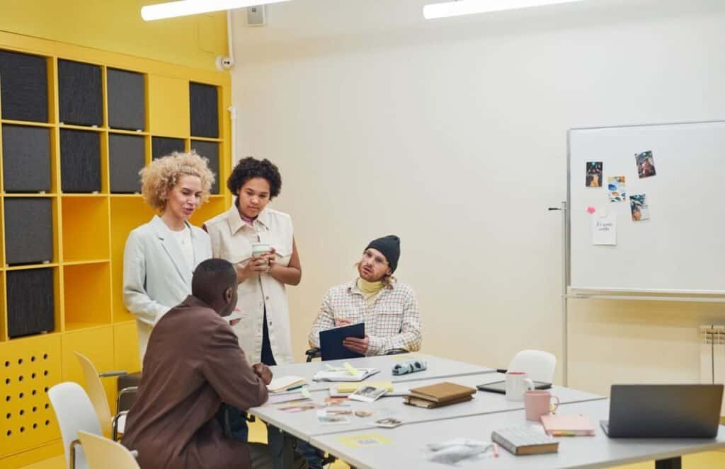 Frameworks & Guides A diverse group of professionals having a collaborative meeting in a modern office space.